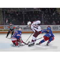 Peterborough Petes' J.R. Avon battles Marcus Vandenberg and Hunter Brzustewicz of the Kitchener Rangers