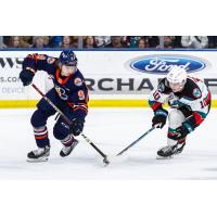 Kelowna Rockets left wing Turner McMillen (right) skates against the Kamloops Blazers