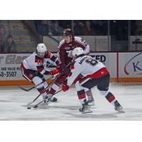 Peterborough Petes' Tommy Purdeller battles Ottawa 67's Henry Mews and Frankie Marrelli