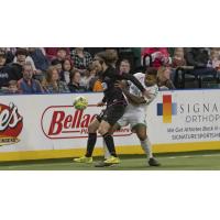 St. Louis Ambush forward Brian Bemet fends off the Dallas Sidekicks