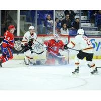 Vancouver Giants right wing Skyler Bruce (left of goal) and centre Kyren Gronick (far right) vs. the Spokane Chiefs