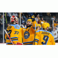 Toledo Walleye goaltender Sebastian Cossa celebrates with teammates