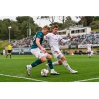 Phoenix Rising's Emil Cuello (in white) defends a cross against the San Diego Loyal