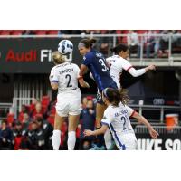 Washington Spirit forward Ashley Hatch (center) goes high for the ball