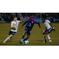 South Georgia Tormenta FC's Andrew Akindele versus Charlotte Independence's Brad Dunwell and Avionne Flanagan