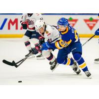 Saskatoon Blades left wing Jordan Keller (right) against the Regina Pats