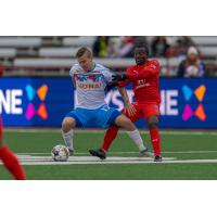 Las Vegas Lights FC midfielder Jacob Bushue eyes the ball against Indy Eleven