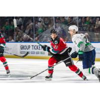 Kelowna Rockets' Gabriel Szturc and Seattle Thunderbirds' Nolan Allan in action