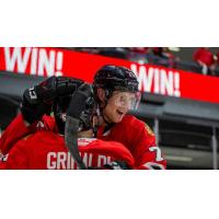 Rockford IceHogs' Rocco Grimaldi and Alec Regula celebrate win