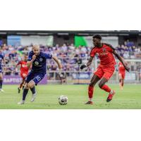 Louisville City FC forward Brian Ownby (left) eyes the ball