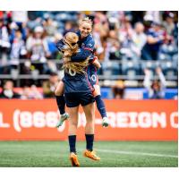 OL Reign midfielcder Jess Fishlock and forward Bethany Balcer celebrate a goal