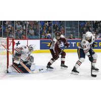 Peterborough Petes' Tucker Robertson battles Kamloops Blazers' Dylan Ernst and Ethan Brandwood