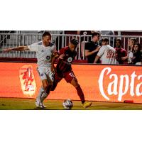 Louisville City FC's Sean Totsch battles Phoenix Rising FC's Danny Trejo