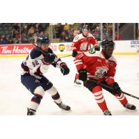 Saginaw Spirit's Nicholas Sima and Kingston Frontenacs' Maleek McGowan in action